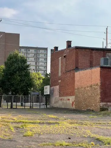 City layers: old brick meets modern sky.